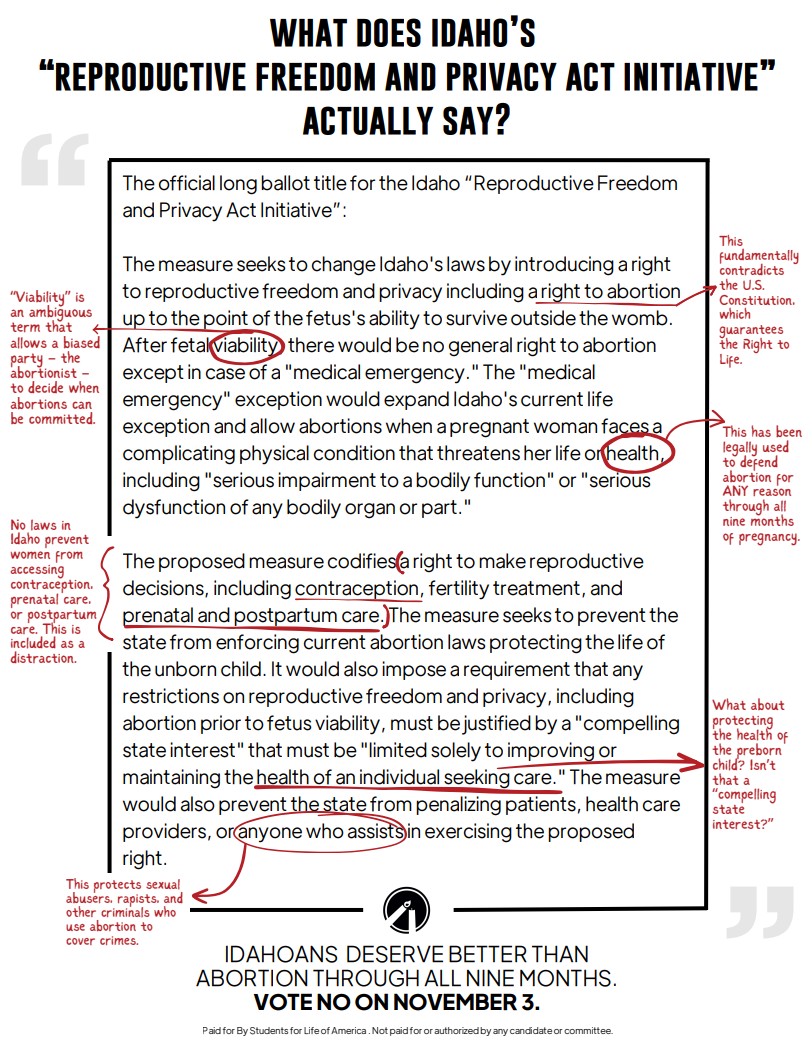 A group of people stand and sit closely together, smiling at the camera.