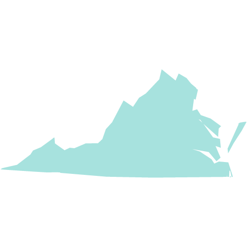 A group of people stand and sit closely together, smiling at the camera.