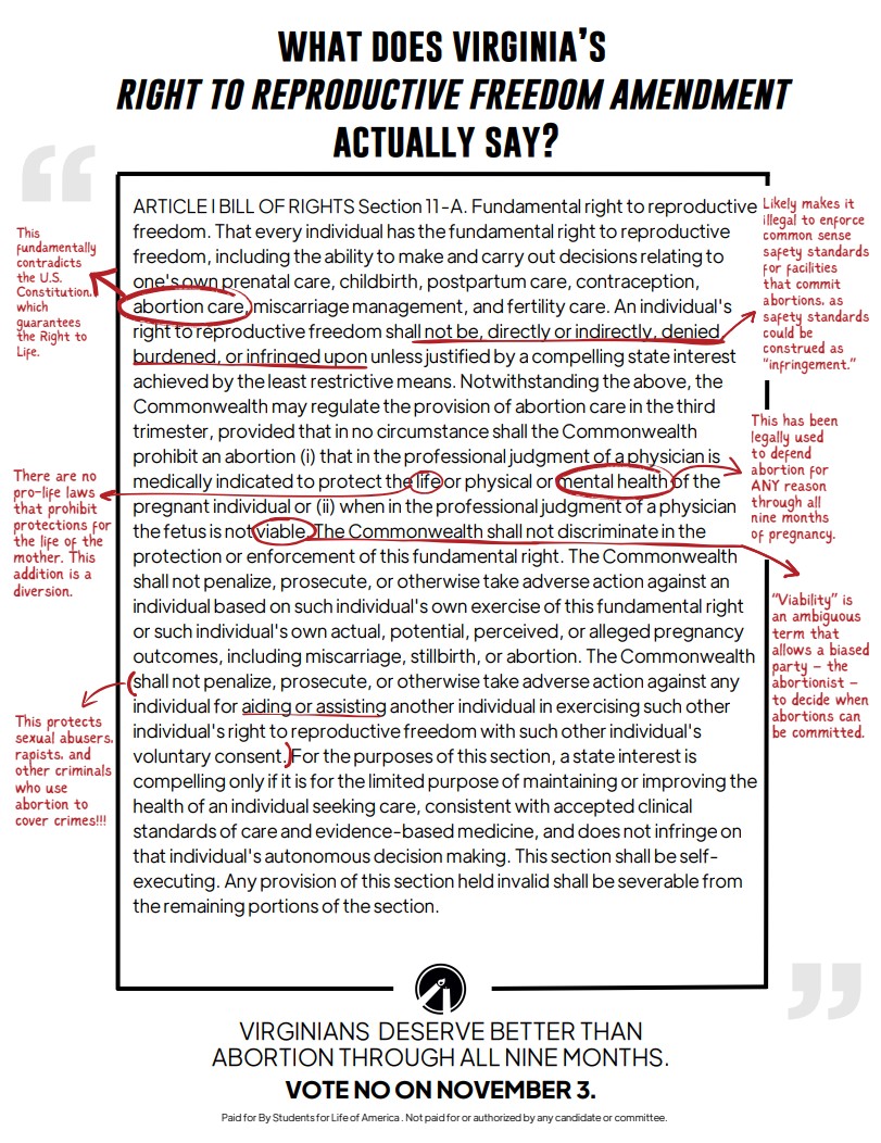 A group of people stand and sit closely together, smiling at the camera.